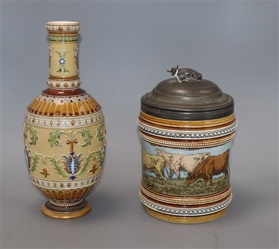 A Mettlach vase with floral decoration and a biscuit jar decorated with cattle